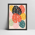 Tropical monstera leaves art print in bold colors in a black frame