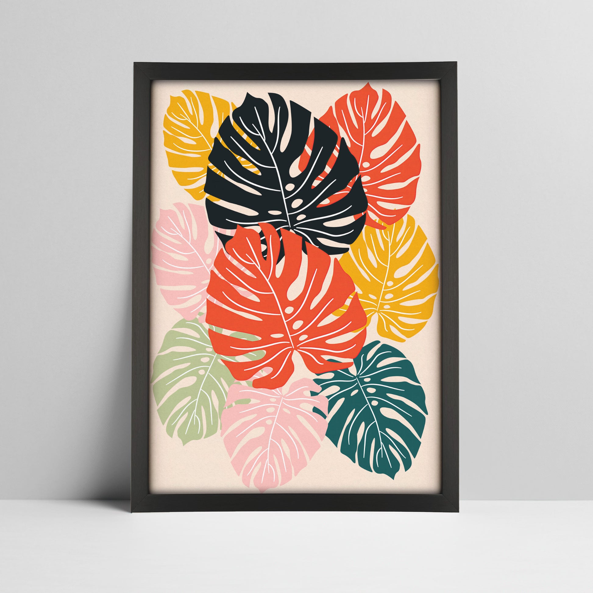 Tropical monstera leaves art print in bold colors in a black frame