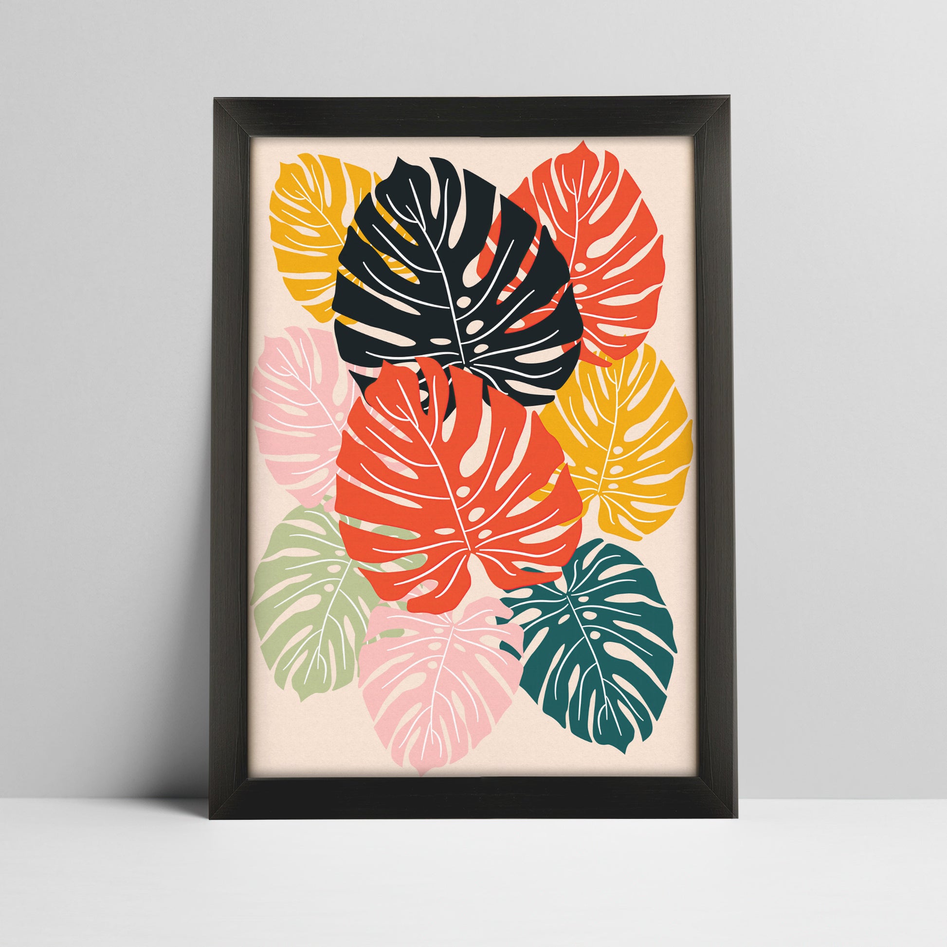 Tropical monstera leaves art print in bold colors in a thick black frame