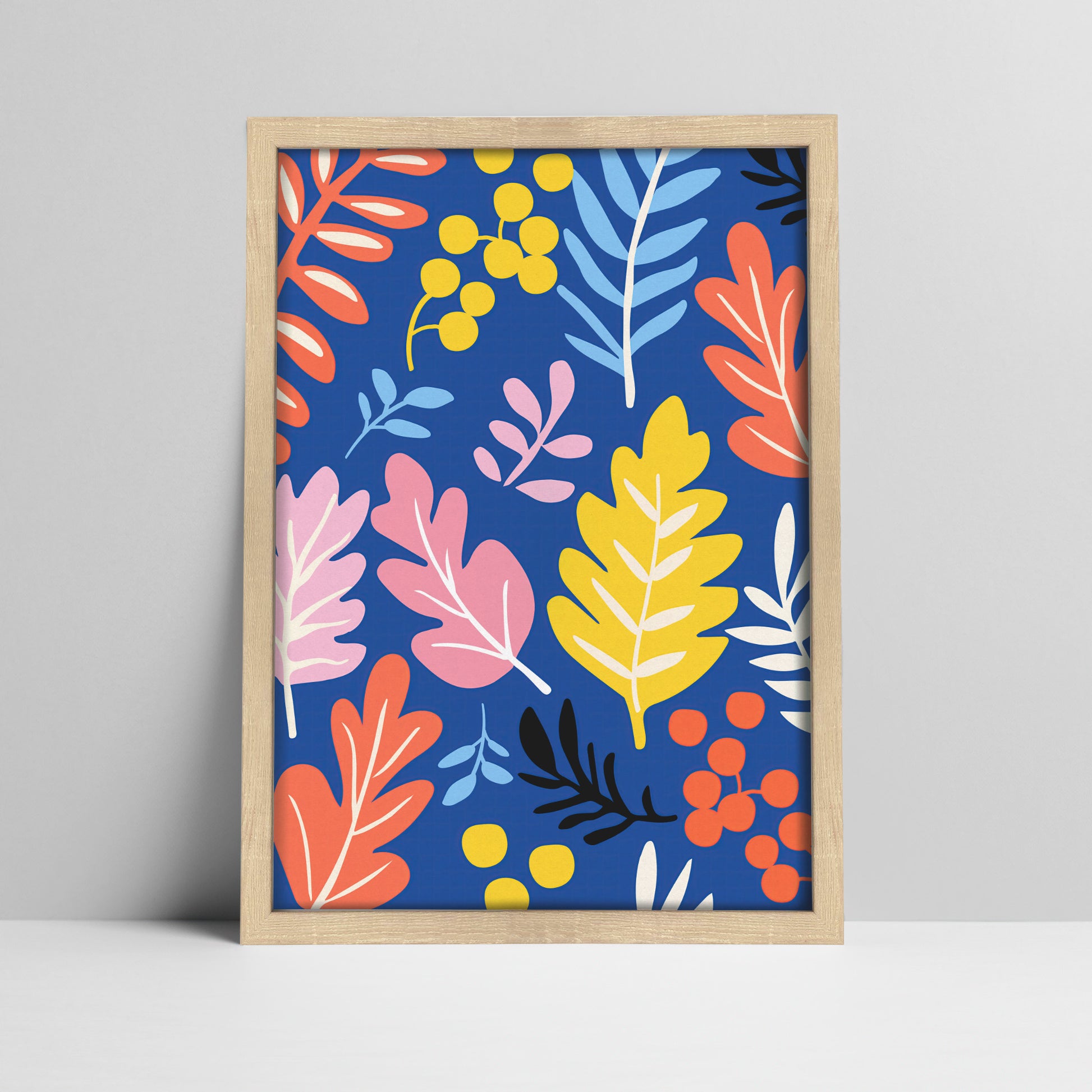 Vibrant botanical print with blue background in a light wood frame